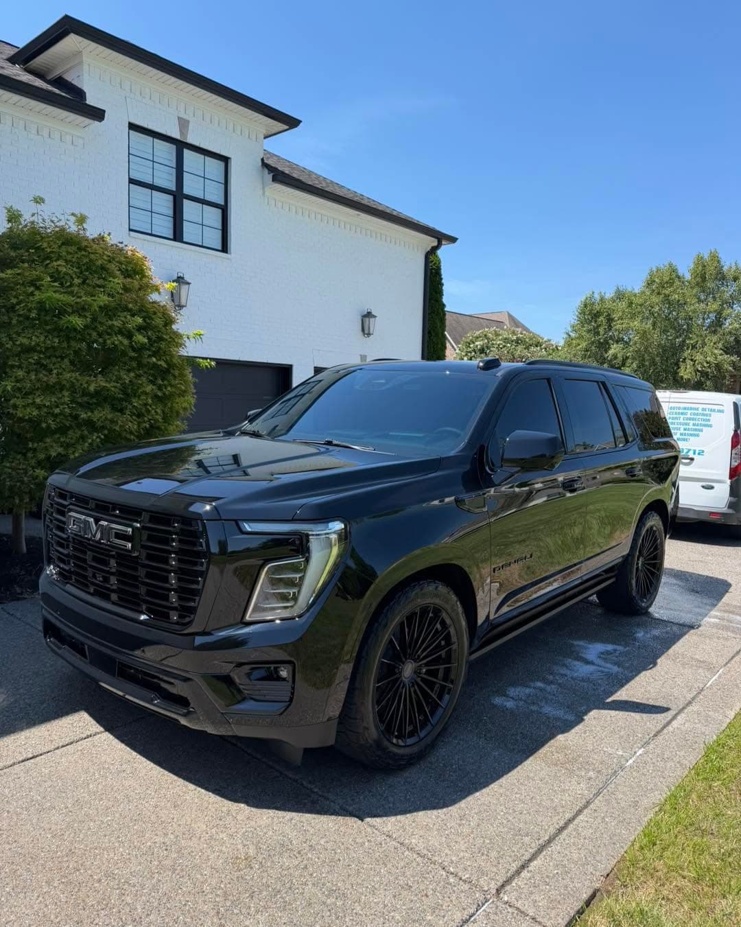 Black Yukon Denali, our van behind after an exterior detail