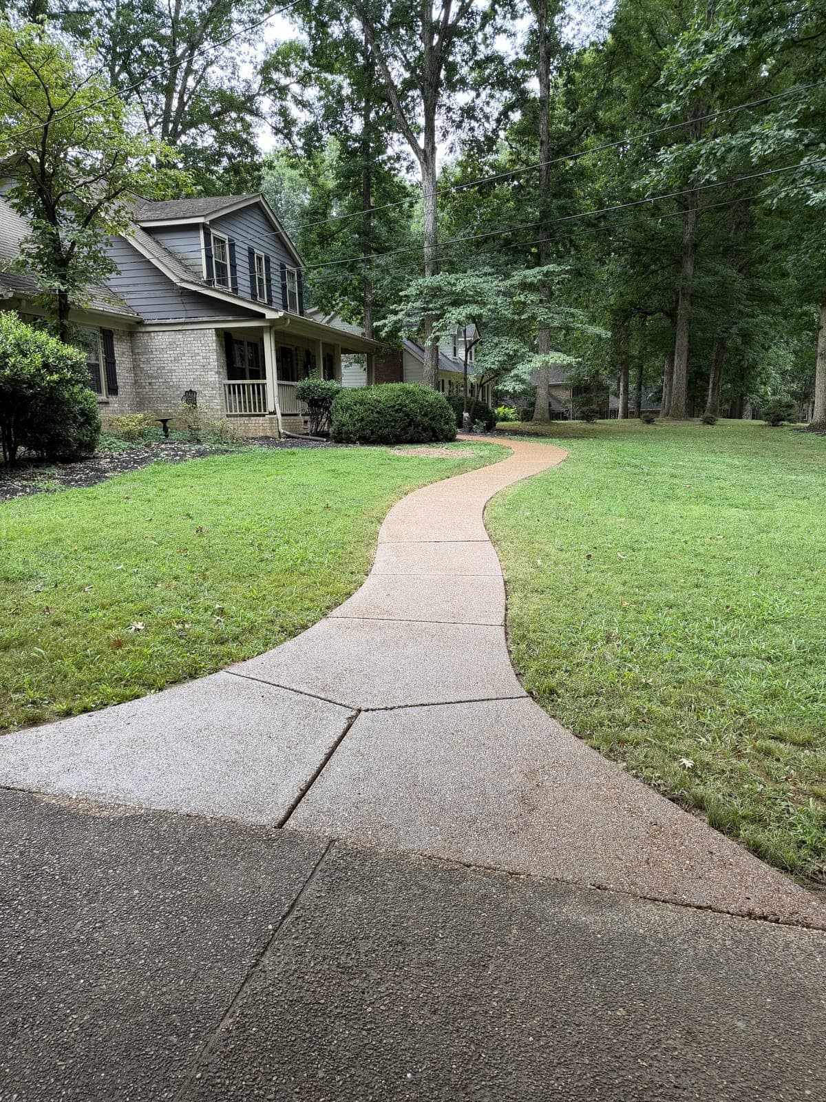 Curved concrete walkway after pressure washing